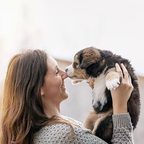 A woman holding her puppy